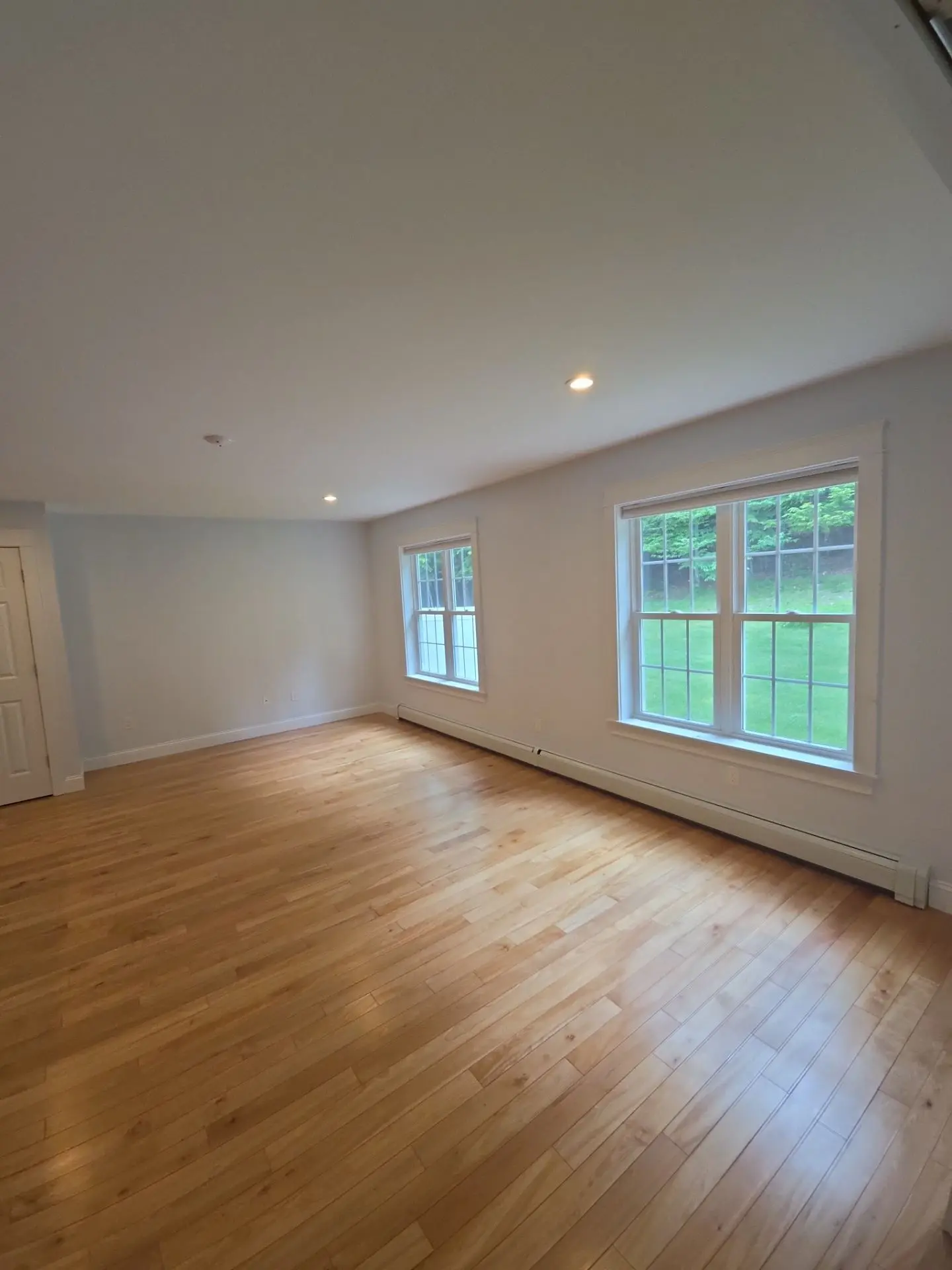 Bright Residential Bedroom Interior Painting A clean, freshly painted residential bedroom or office space with light walls and hardwood floors.